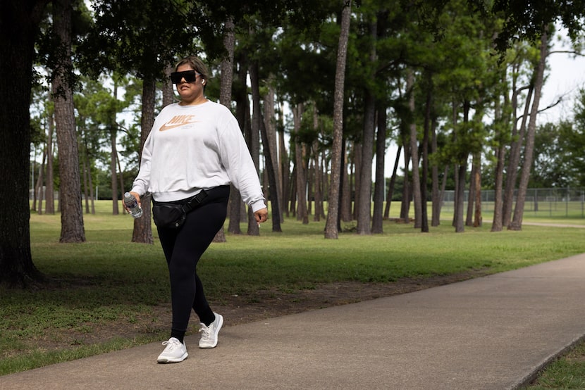 Mayra Servantes walks the Crawford Memorial Park Loop on July 1, 2025, in Dallas. 