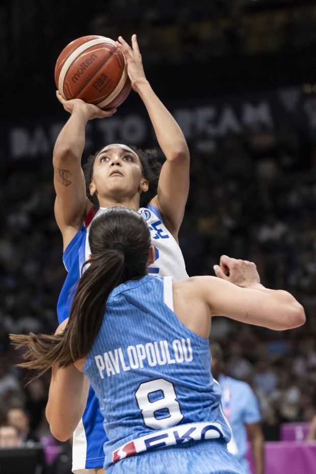 Leila Lacan of France, top, shoots past Pinelopi Pavlopoulou of Greece during the European Championships basketball match between France and Greece at the Peace and Friendship Stadium in Piraeus near Athens, Greece, Thursday, June 19, 2025. (Alessandro della Valle/Keystone via AP)
