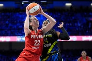 Indiana Fever guard Caitlin Clark (22) leaps to the basket for a shot as Dallas Wings' Arike...