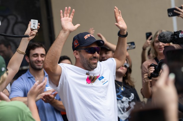 Jason Nagin takes the $50 prize and a bag of pickles after winning an Adam Sandler lookalike contest in Vesuvio Playground in Manhattan on Friday, June 19, 2025. (Barry Williams / New York Daily News)