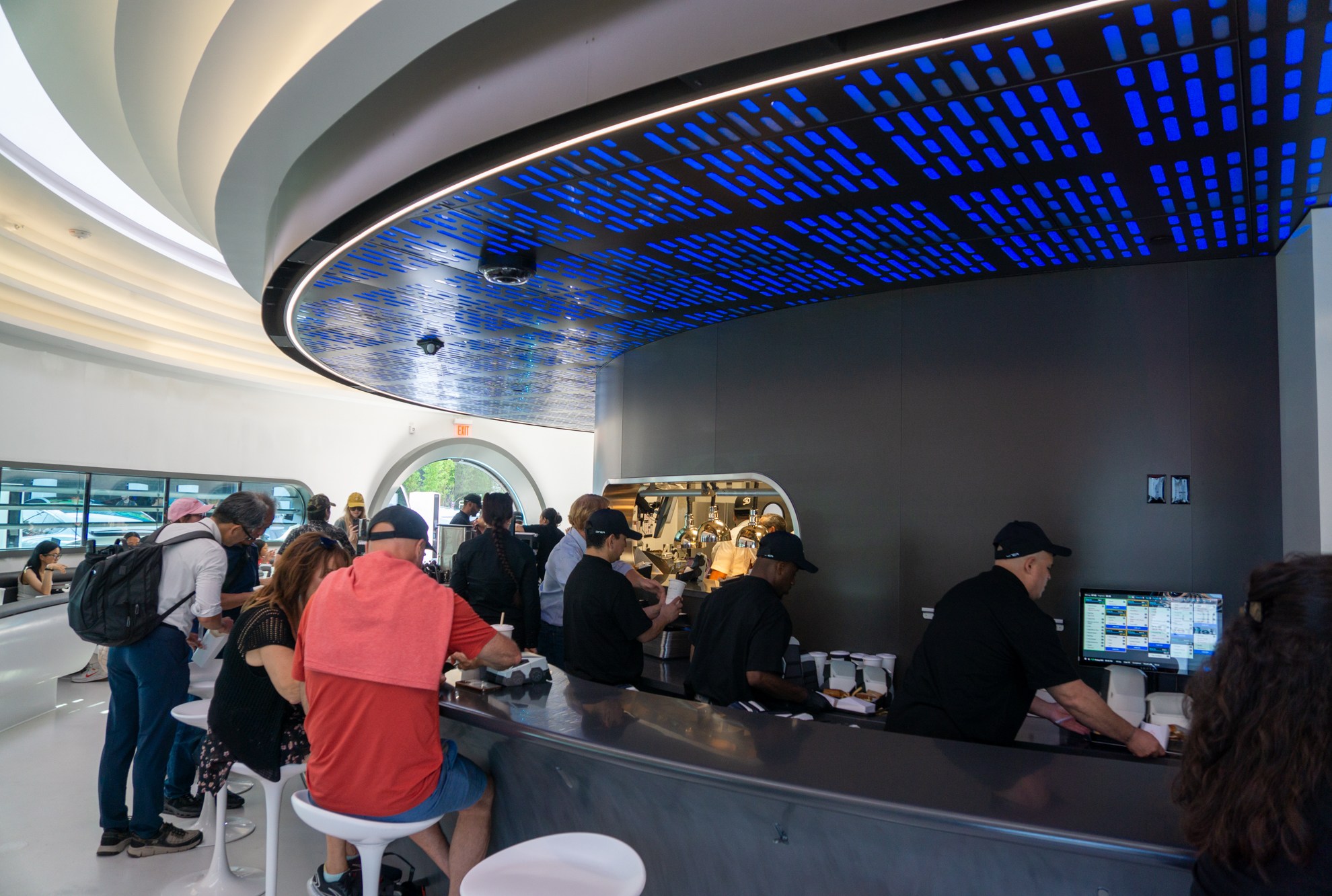 Workers and diners at a LA restaurant themed by Tesla.