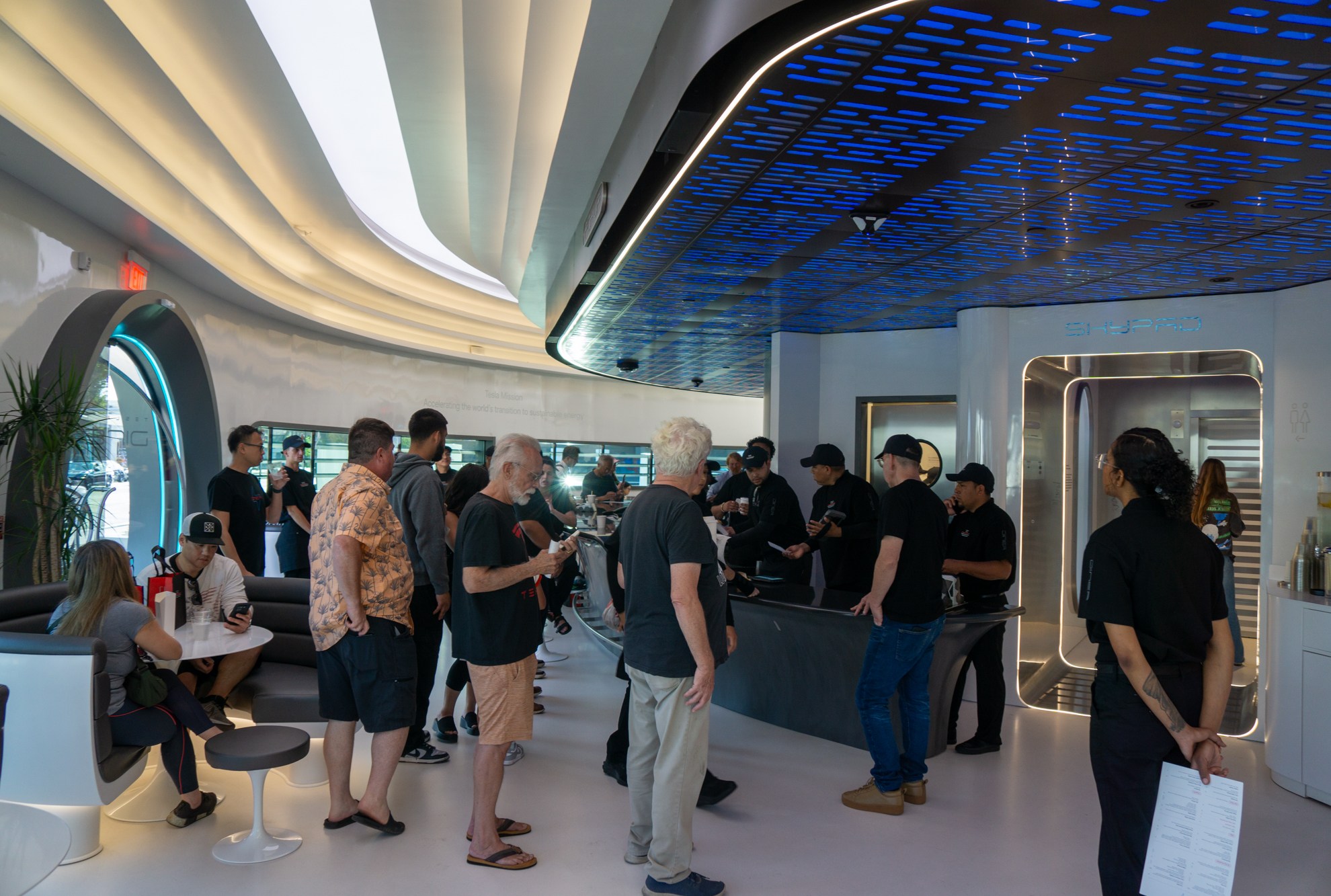 Workers fulfill orders while customers wait for food at Tesla Diner.