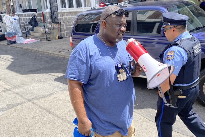 Police Department Chaplain Moses Cotton used a bullhorn to offer words of comfort to South Etting Street residents.