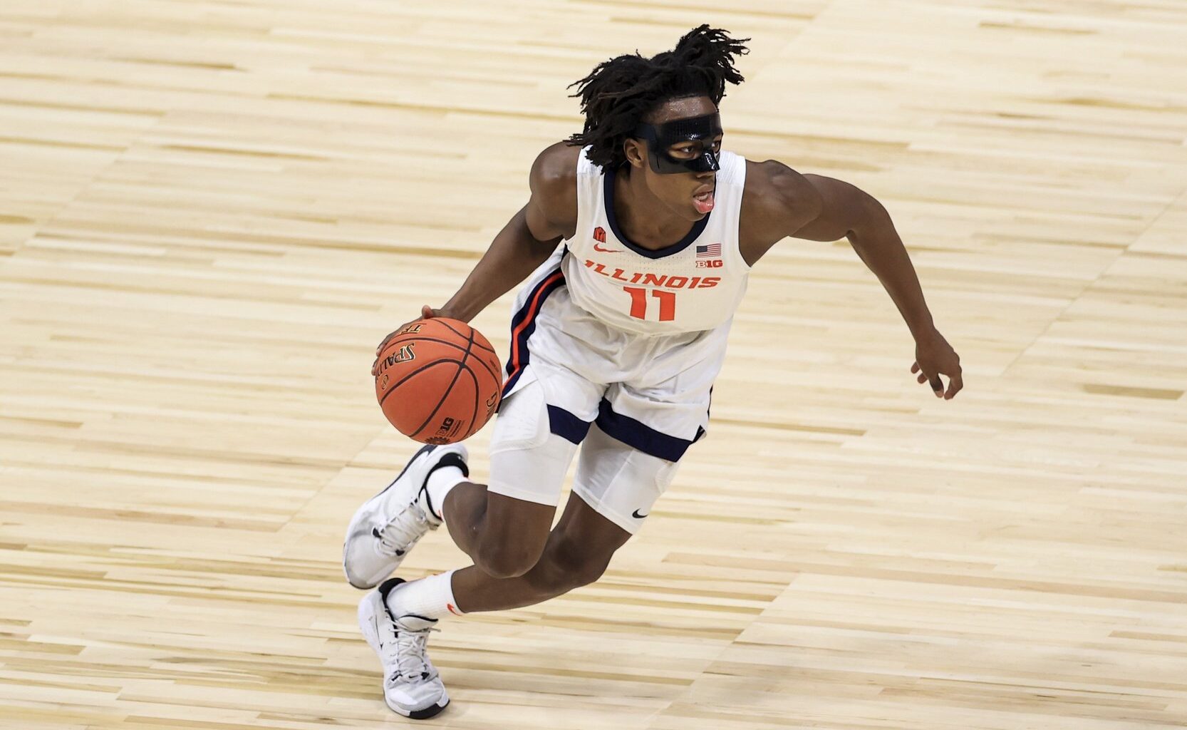 Illinois Fighting Illini guard Ayo Dosunmu (11) controls the ball in the game against the Rutgers Scarlet Knights in the first half at Lucas Oil Stadium.