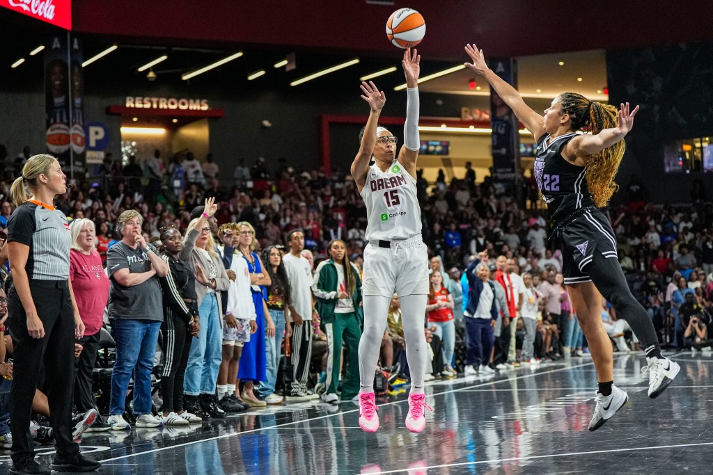 Allisha Gray shoots over the outstretched hand of a defender closing out outside the 3-point arc