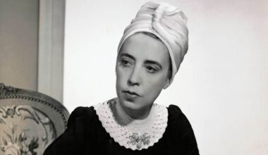 Designer Elsa Schiaparelli wearing black silk dress with crocheted collar of her own design and a tuban. (Photo by Fredrich Baker/Condé Nast via Getty Images)