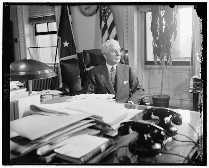 Secretary of State Cordell Hull sits at his desk, c. 1940. Hull served in the cabinet of...