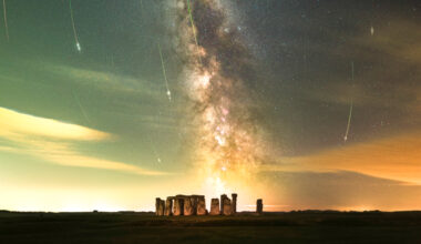 The Milky Way galaxy glows over the rock structure of Stonehenge.