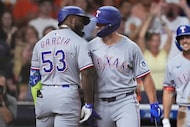 Texas Rangers' Adolis García (53) celebrates with Wyatt Langford after hitting a solo home...