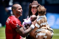 Dallas Cowboys quarterback Dak Prescott (4) takes his newborn daughter Aurora Rayne from his...