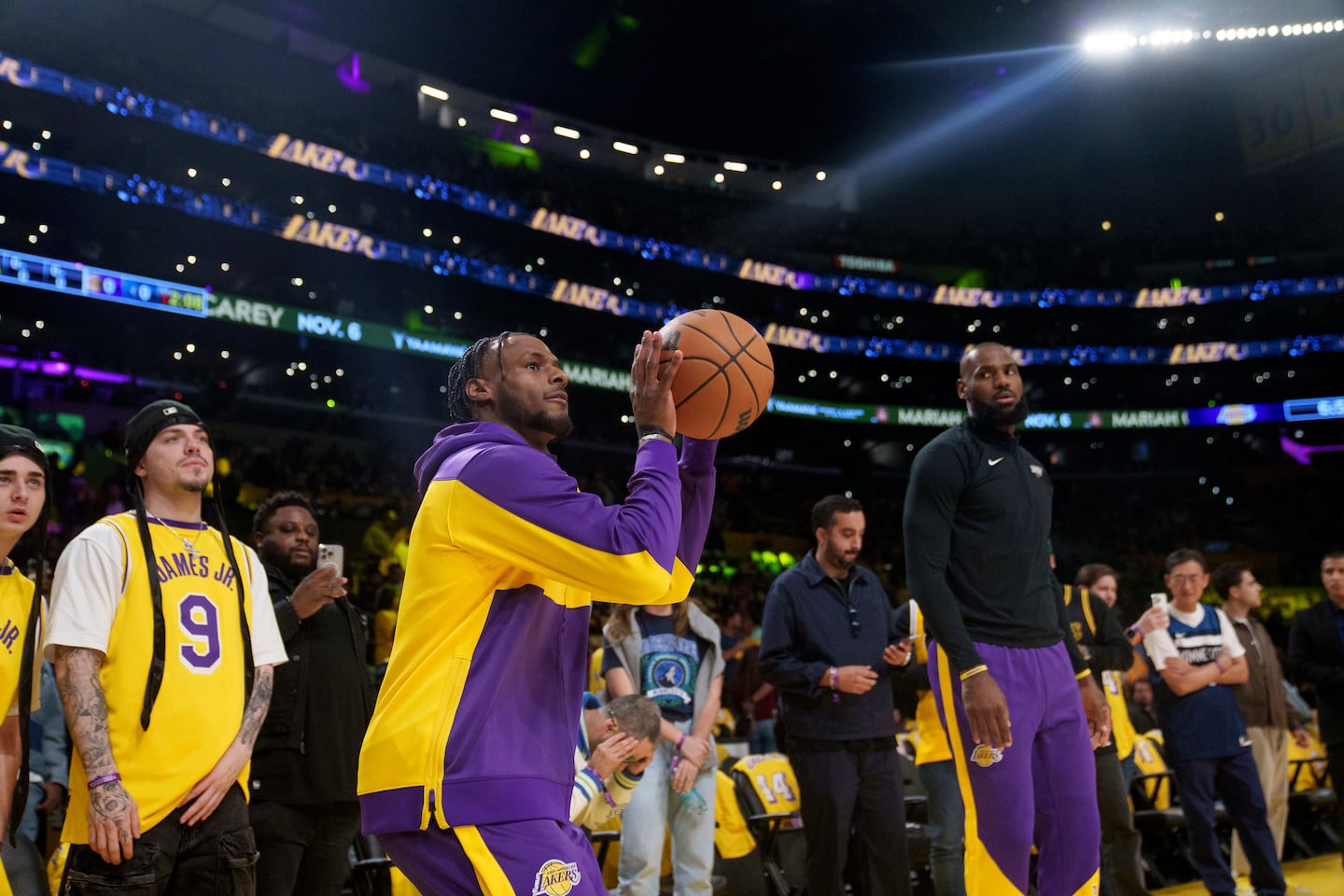 Bronny James (left) and LeBron James warm up before a game against the Timberwolves in October.