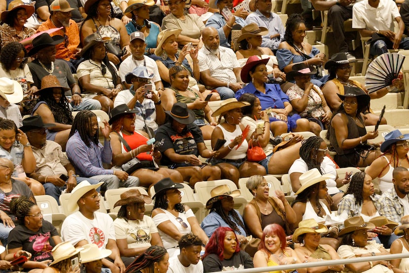 People cheer during Texas Black Invitational Rodeo at Fair Park Coliseum, Saturday, July 26,...
