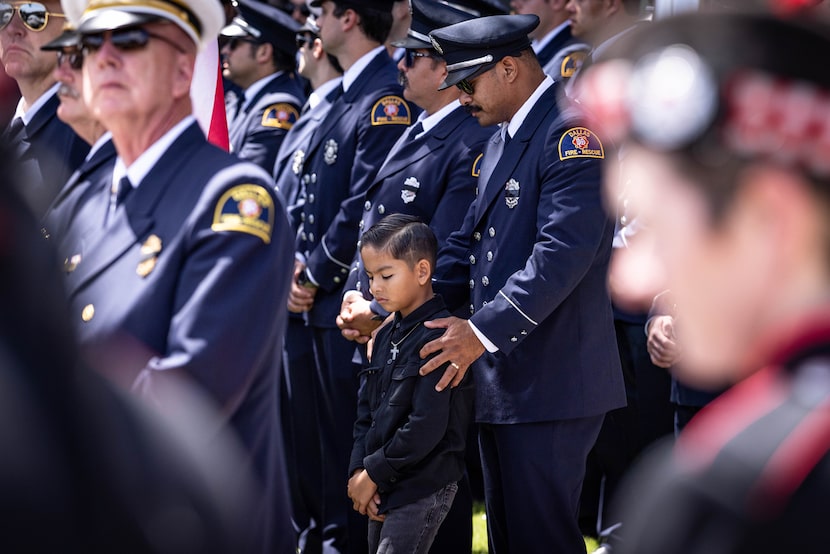 Dallas Fire-Rescue firefighter and paramedic Mac Belino and son Ezra Belino line a...