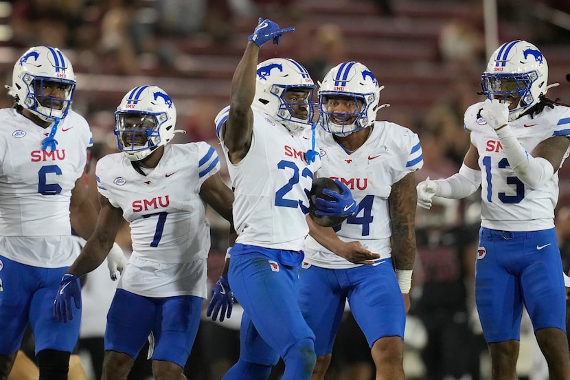 SMU safety Isaiah Nwokobia (23) celebrates with teammates after intercepting a pass against...