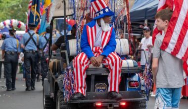 Elijah Thomas,14, with the Philadelphia Police Explorer Cadets rides as Uncle Sam.