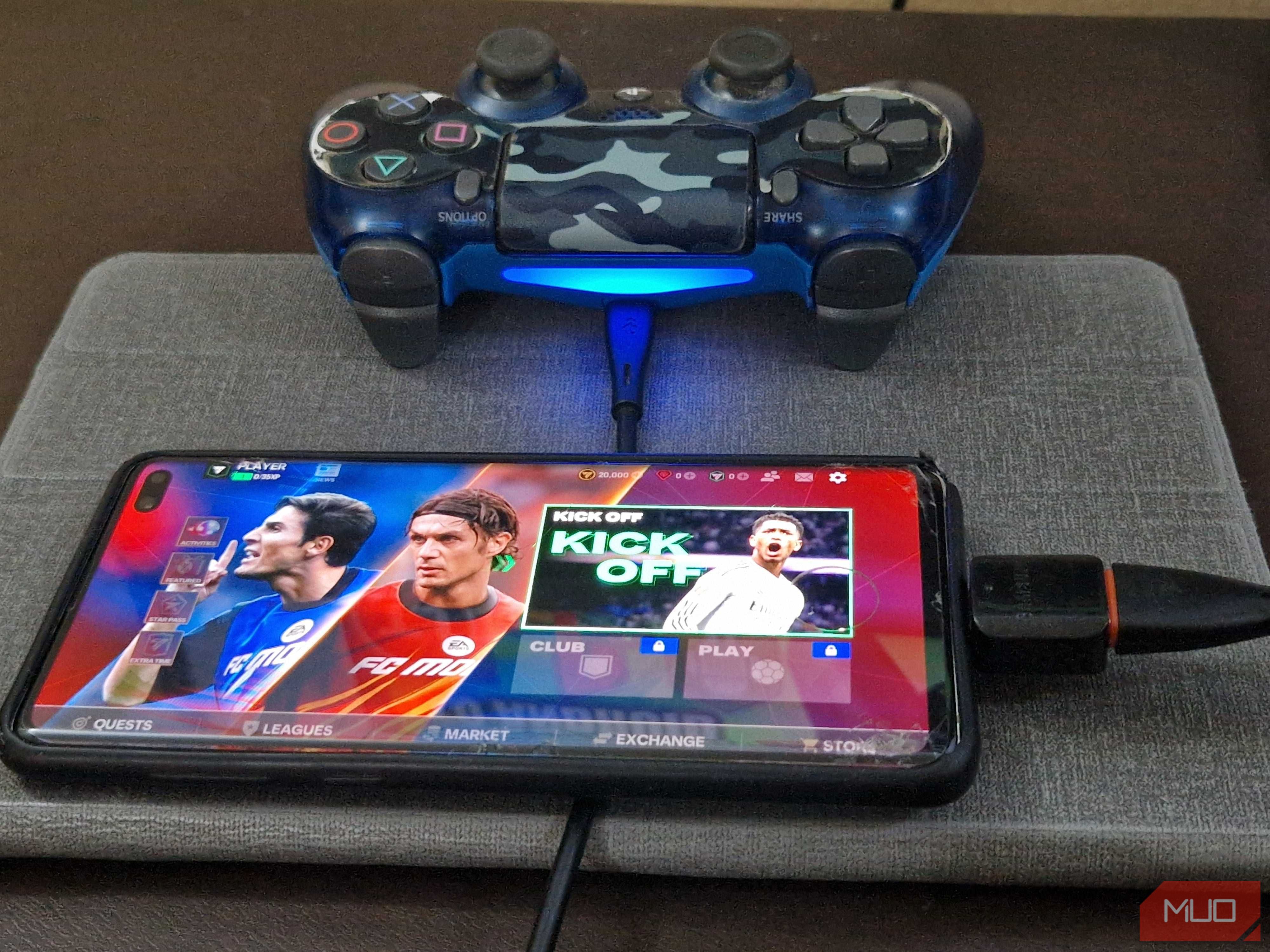 A PS4 controller plugged to a smartphone via an OTG adapter and USB cable.