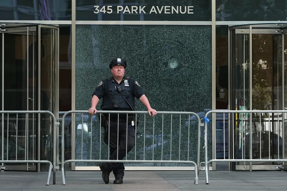 An NYPD officer stands outside the building where the mass shooting occurred.