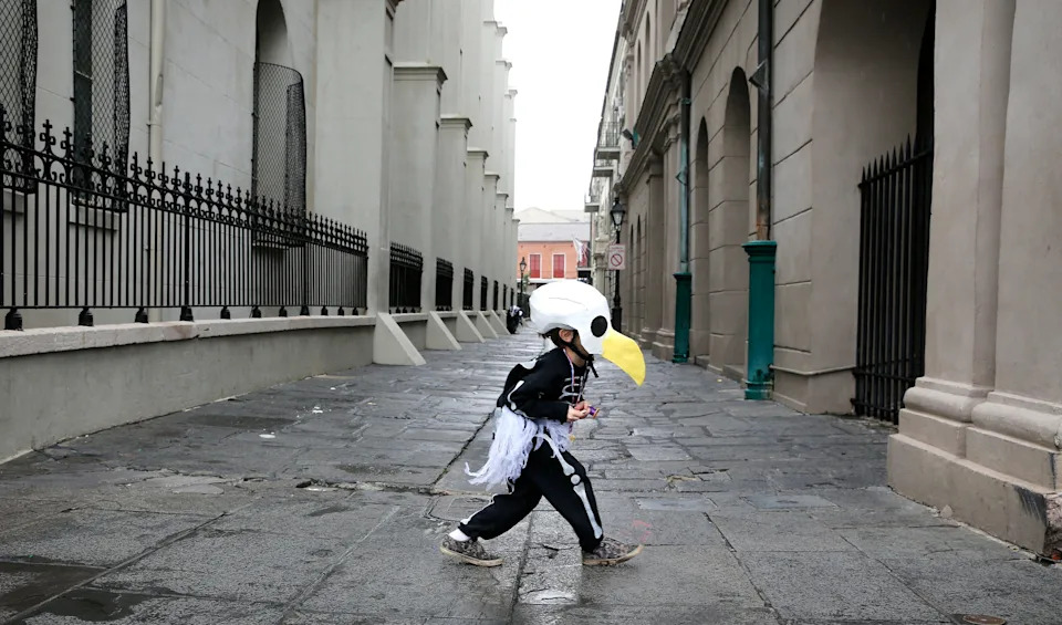 Brody Bell, 6, of New Orleans, runs across Pierre Antoine Alley dressed as a bald eagle.