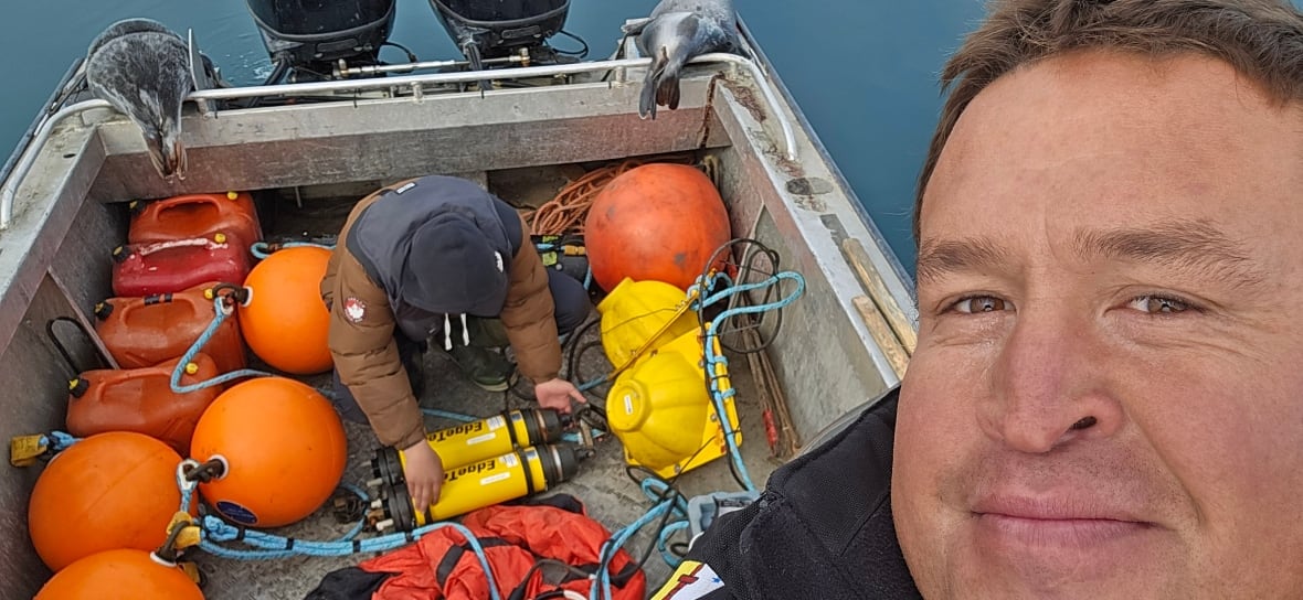 Researcher Alex Ootoowak on the ocean checking the hydrophones, which measure frequencies on July 24. Ootoowak says he is passing on his knowledge about narhwals and the area to his son and nephews.
