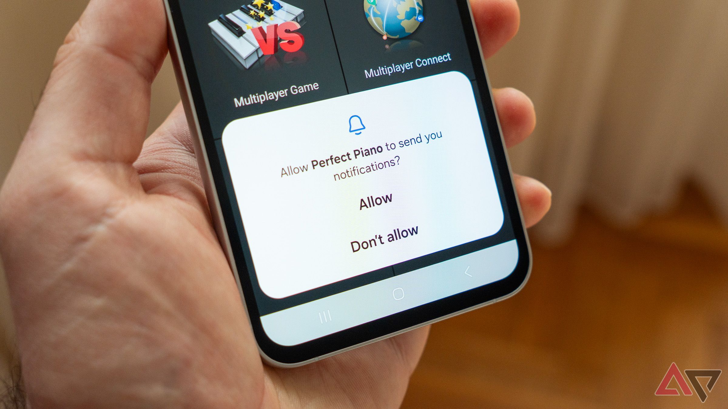 a phone in hand asking for permission to display notifications