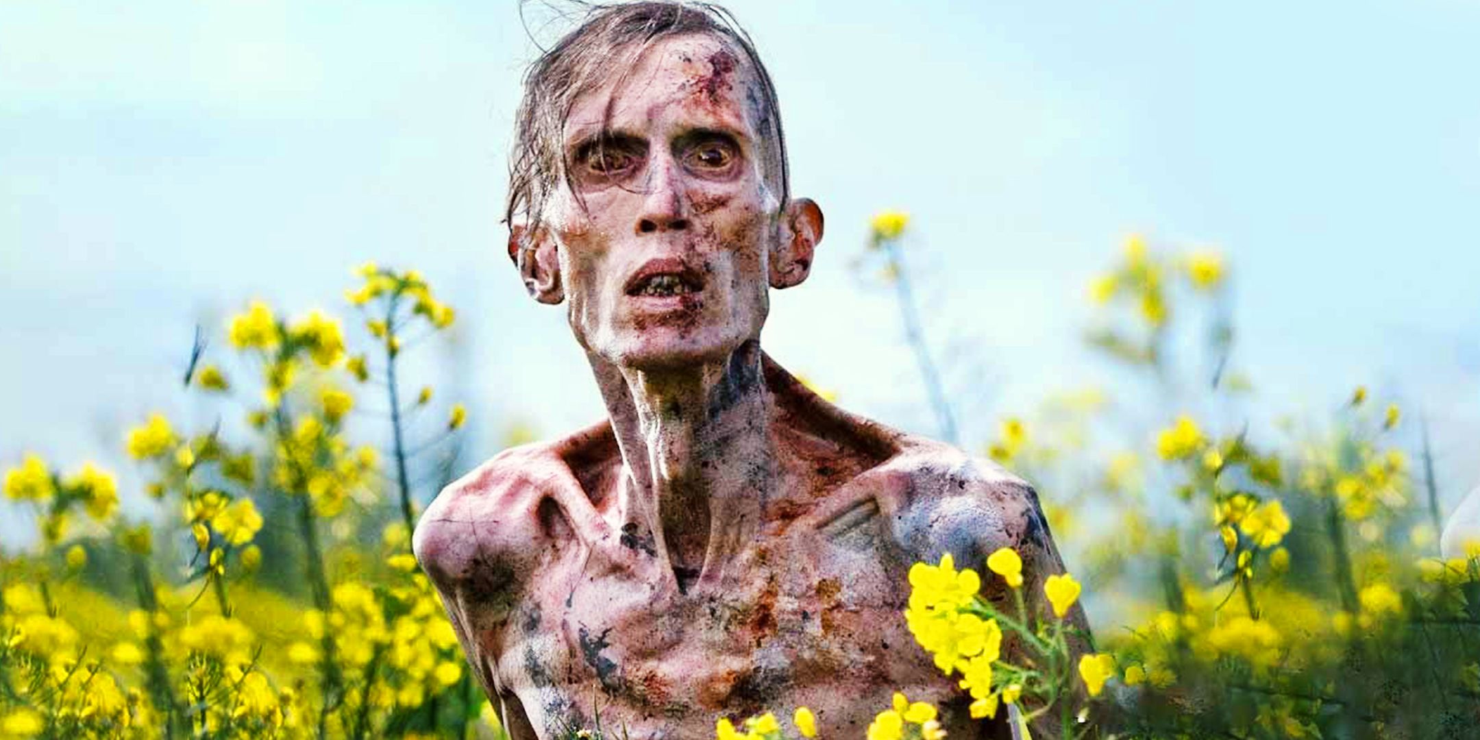 Angus Neil as an Infected surrounded by yellow flowers in 28 Years Later