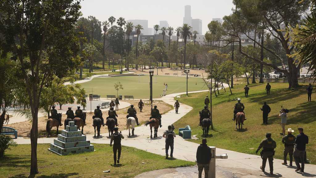 Federal officers with military vehicles deploy to Los Angeles park