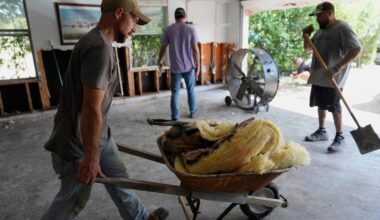 Volunteers help clean up a house after flooding in Kerrville, Texas on Tuesday, July 8, 2025. (AP Photo/Ashley Landis)