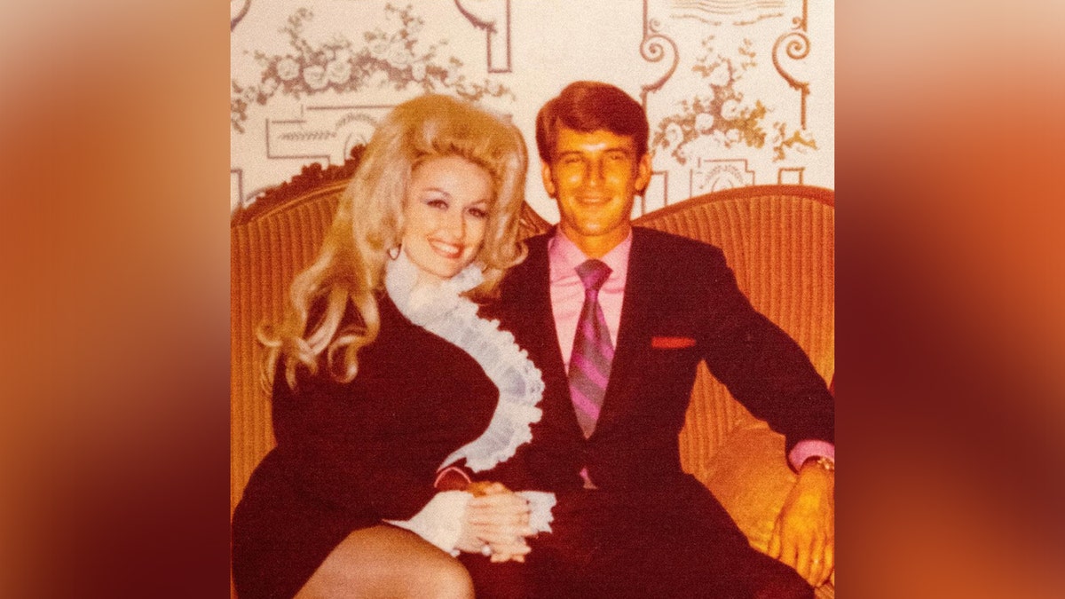 Dolly Parton and Carl Dean sitting on a couch