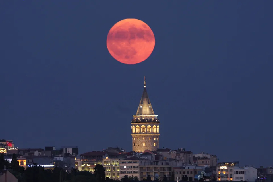 The buck moon rises over the Galata Tower in Istanbul.
