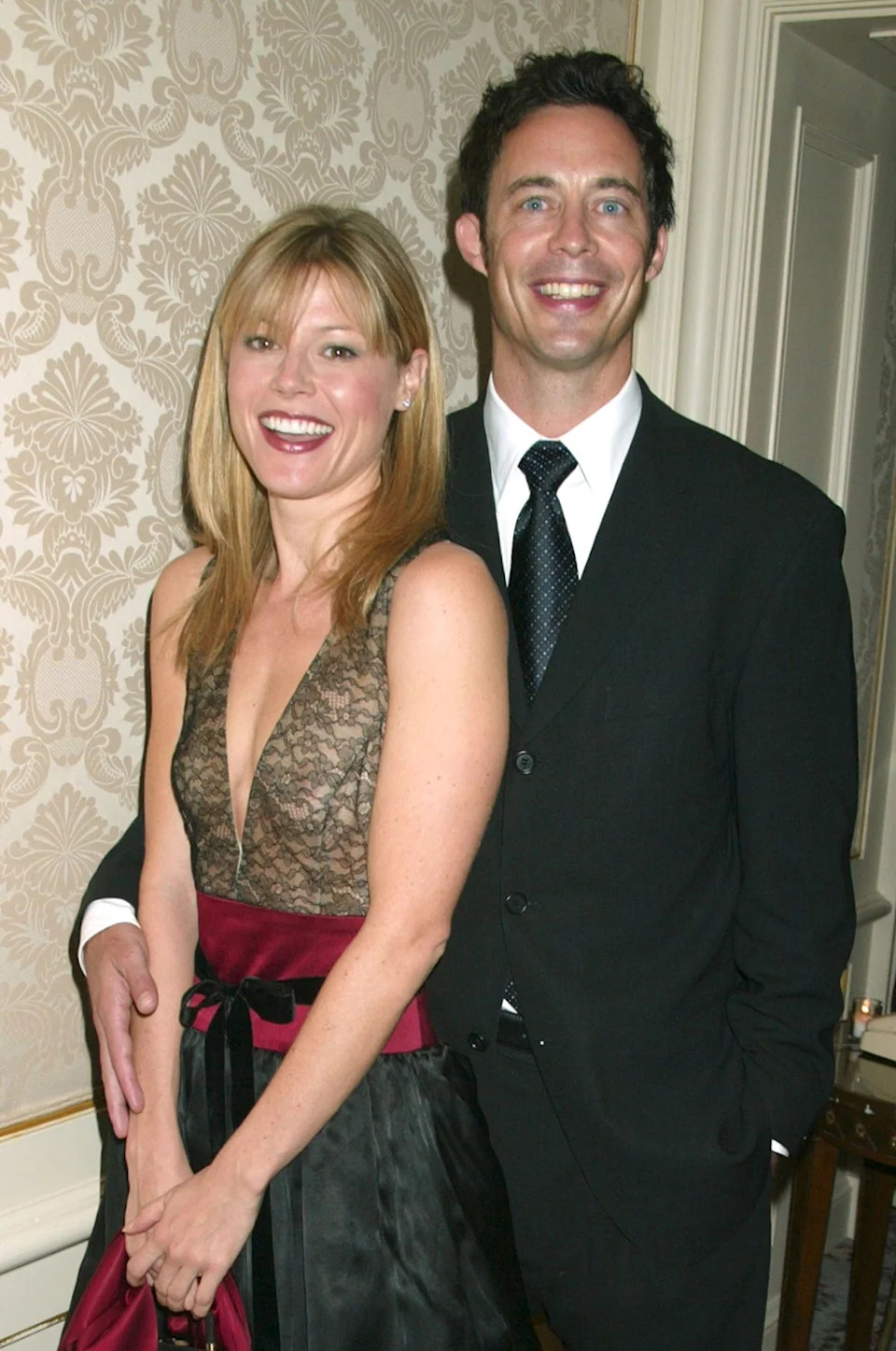 Julie Bowen smiling with her "Ed" co-star in a suit and black tie.