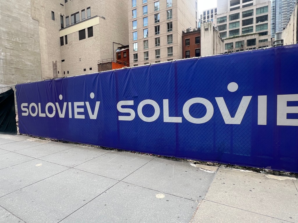 Construction site fence with Soloviev logo.