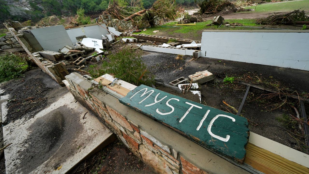 A Camp Mystic sign is seen near the entrance to the establishment along the banks of the Guadalupe River in Hunt, Texas, Saturday, July 5, 2025, after a flash flood swept through the area. (AP Photo/Julio Cortez)