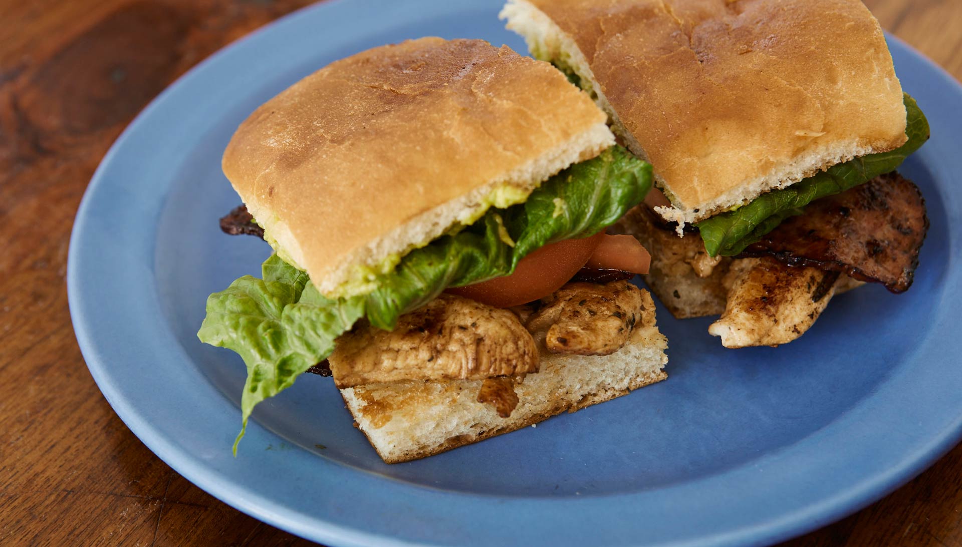 Two chicken sandwiches on a plate.