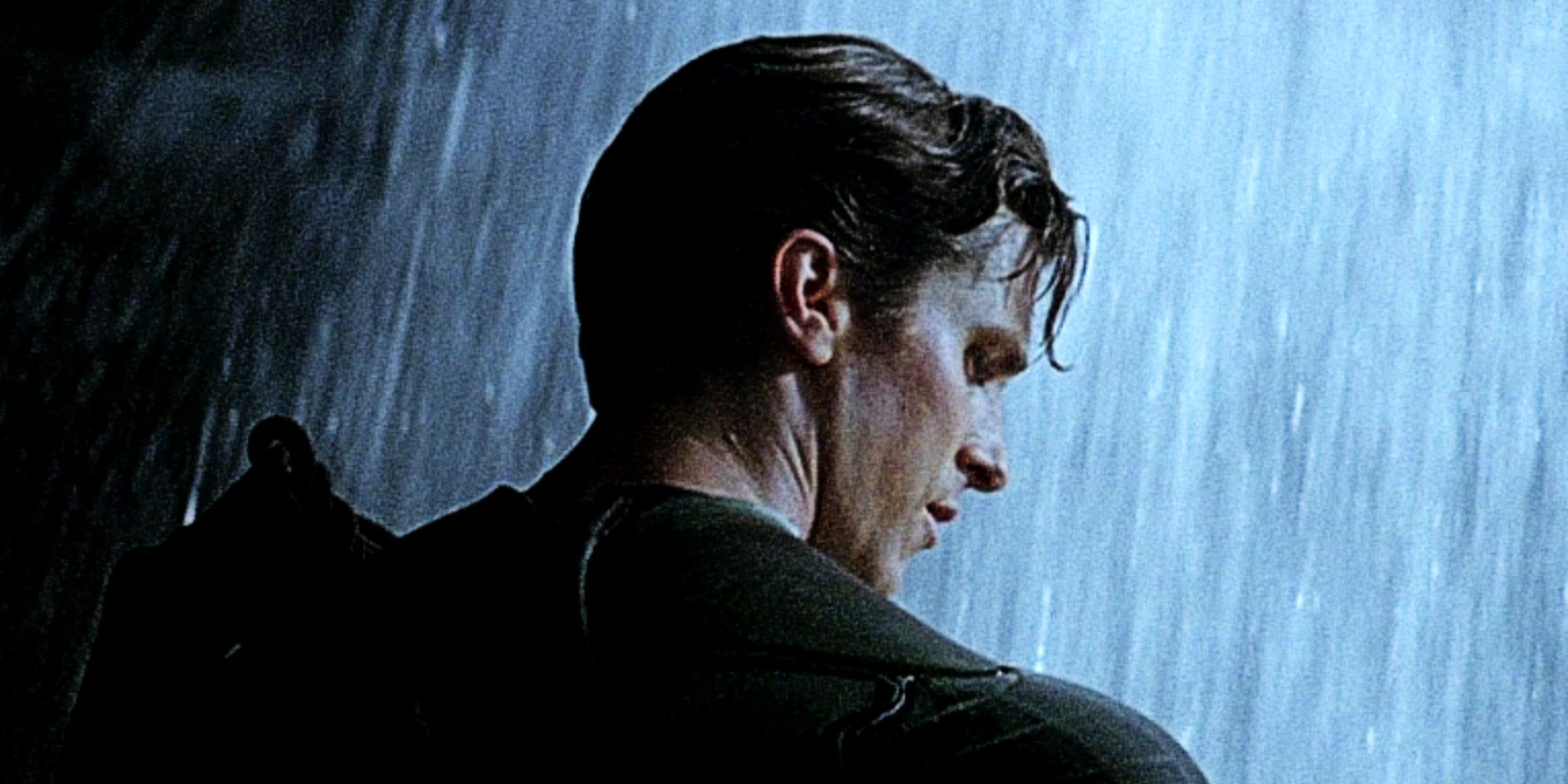 Christian Bale's Bruce Wayne takes off his Dark Knight mask inside the Batcave in Christopher Nolan's Batman Begins