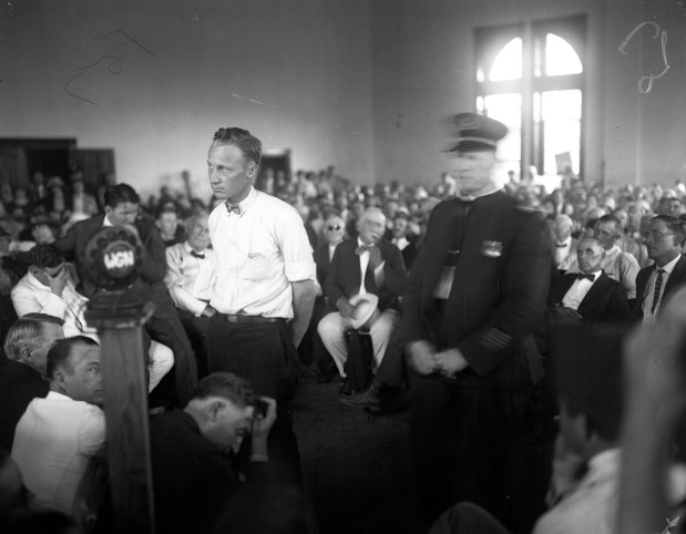 School teacher John Scopes of Dayton, Tennessee, stands before Judge Raulston while on trial in July 1925 for teaching human evolution in school, in violation of Tennessee's Butler Act. (Chicago Herald and Examiner) 