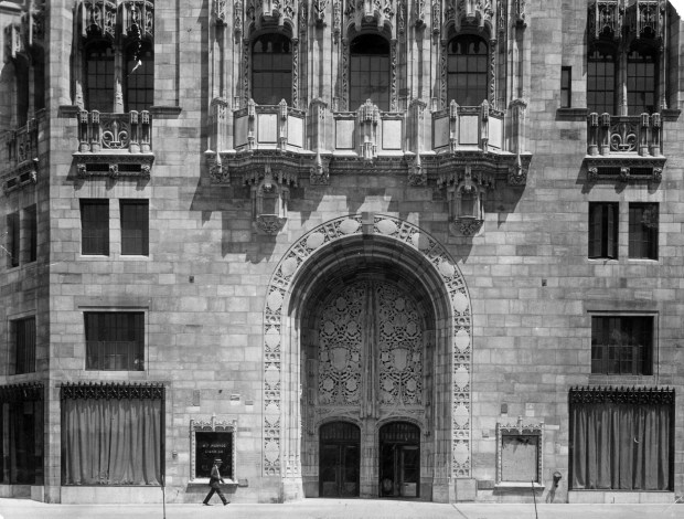 The entrance to Tribune Tower and the features of the front exposure are visible to the public in July 1925. The removal of the temporary facade revealed a delicate sculpture, "Tree of Life," over the doorway and also shows the stones taken from historic buildings that are inlaid in the front wall. The building officially opened on July 6, 1925. (Chicago Tribune historical photo) 