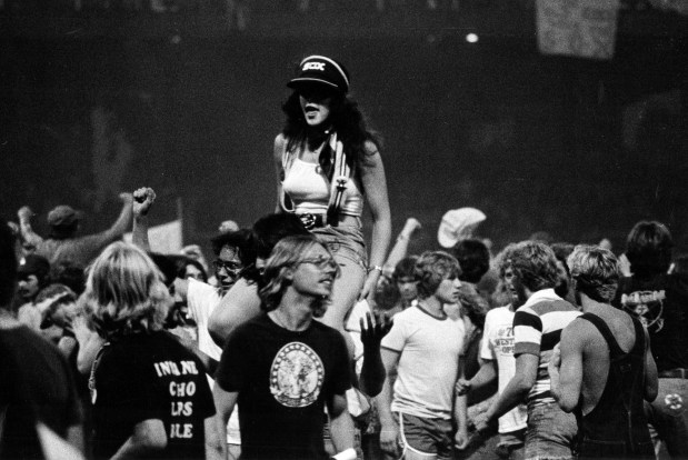 The evening got off to a bad start when 15,000 too many fans showed up at Comiskey Park and were unable to buy tickets on July 12, 1979. Police beefed up their patrol outside the park to 100 but chaos reigned inside as fans roamed the field at will, carrying anti-disco placards and chanting. (Ed Wagner Jr./Chicago Tribune)