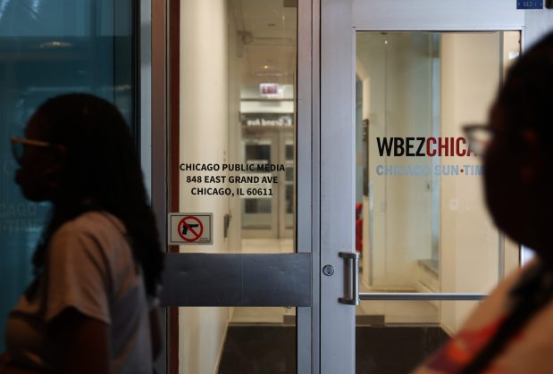 People walk past the entrance to the Chicago Public Media and WBEZ newsroom at Navy Pier on July 15, 2025, in Chicago. (John J. Kim/Chicago Tribune)