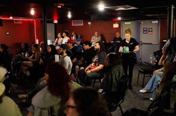 People attend a show at the Comedy Plex Comedy Club,...