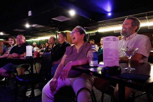 Mary Grace Bertulfo, center, and Alan Schwartz, right, laugh while...