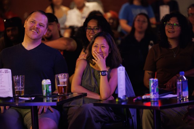 Martin Keller, left, and his fiancé Crystal Pun laugh while...