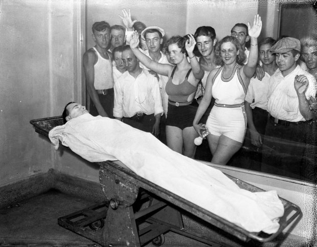 Betty Nelson and Rosella Nelson view the body of John Dillinger, 32, while in bathing suits at the Cook County Morgue, located at Polk and Wood Streets, in Chicago. In the days after Dillinger was killed on July 22, 1934, massive crowds lined up outside the morgue to get a glimpse of the notorious public enemy. (Chicago Herald & Examiner historical photo)