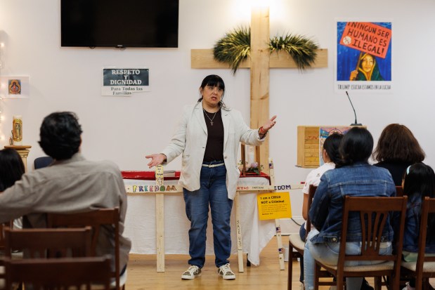 Pastor Julie Contreras talks with multiple families that had been staying at United Giving Hope Sanctuary Church in Waukegan on July 2, 2025, after they received letters from the Department of Homeland Security informing them that their humanitarian parole has been revoked and they must leave the country . (Armando L. Sanchez/Chicago Tribune)