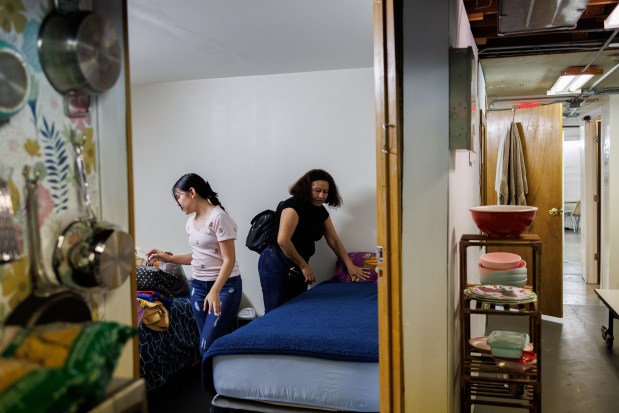 Xally Morales, 13, and her mother Francisca Petra Guzman, fold blankets in the room she had been staying at United Giving Hope Sanctuary Church in Waukegan, July 2, 2025, before leaving the church. (Armando L. Sanchez/Chicago Tribune)