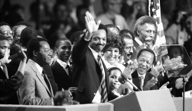 The Rev. Jesse Jackson waves at the beginning of his address to the Democratic National Convention in San Francisco on July 17, 1984. (AP)