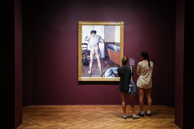 Guests study the "Man at His Bath" painting in the "Gustave Caillebotte: Painting His World" exhibit on July 24, 2025 at the Art Institute of Chicago. (Dominic Di Palermo/Chicago Tribune)