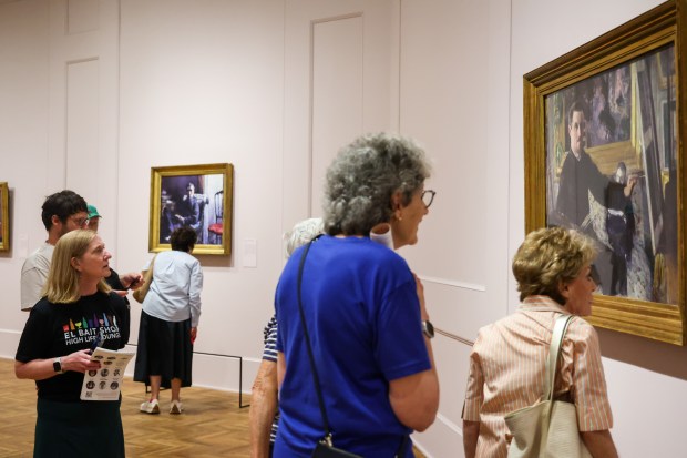 People study the "Self-Portrait with an Easel" painting at "Gustave Caillebotte: Painting His World" exhibit at the Art Institute of Chicago on July 24, 2025. (Dominic Di Palermo/Chicago Tribune)
