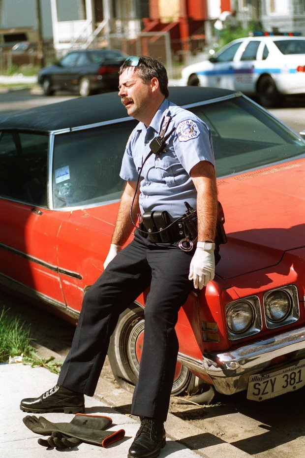 Chicago police officer Charles Henson of the Englewood District is shaken on July 17, 1995, after removing a heat victim's body from an apartment where two people died. (Phil Greer/Chicago Tribune)