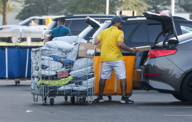 Workers load packages into vehicles outside of a warehouse that includes several businesses including SpeedX along the 2500 block of Busse Road on on July 23, 2025, in Elk Grove Village. (Stacey Wescott/Chicago Tribune)