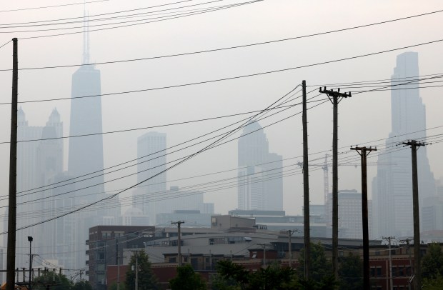 Chicago skyline and Power lines along Halsted Street near Chicago Ave., seen in front of Chicago Skyline on June 28, 2023. (Antonio Perez/ Chicago Tribune)